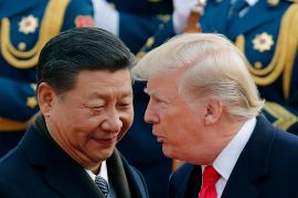 Trump chats with Chinese President Xi Jinping during a welcome ceremony at the Great Hall of the People in Beijing [File: Andy Wong/AP]